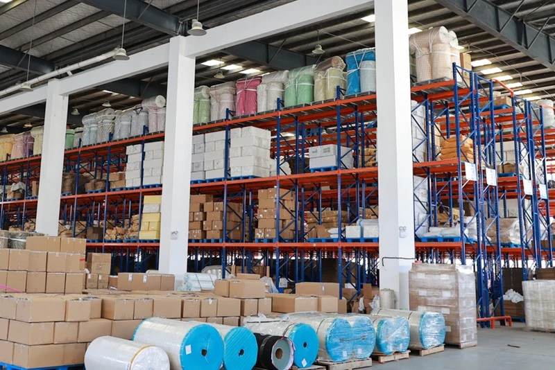 Large quantities of raw materials are piled up in the workshop of the kinesiology tape factory.jpg